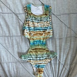 One piece mermaid like swimsuit with cutouts.